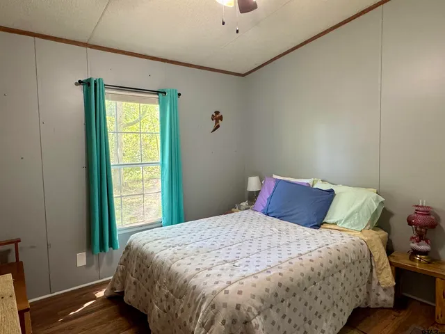 a bed sitting in a bedroom next to a window