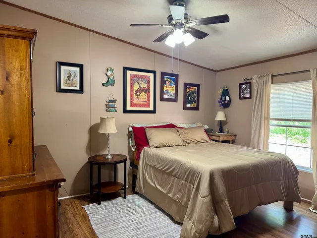 a bedroom with a large bed and a window