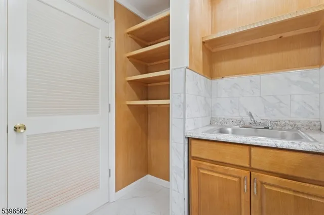 a bathroom with a granite countertop sink mirror vanity and toilet