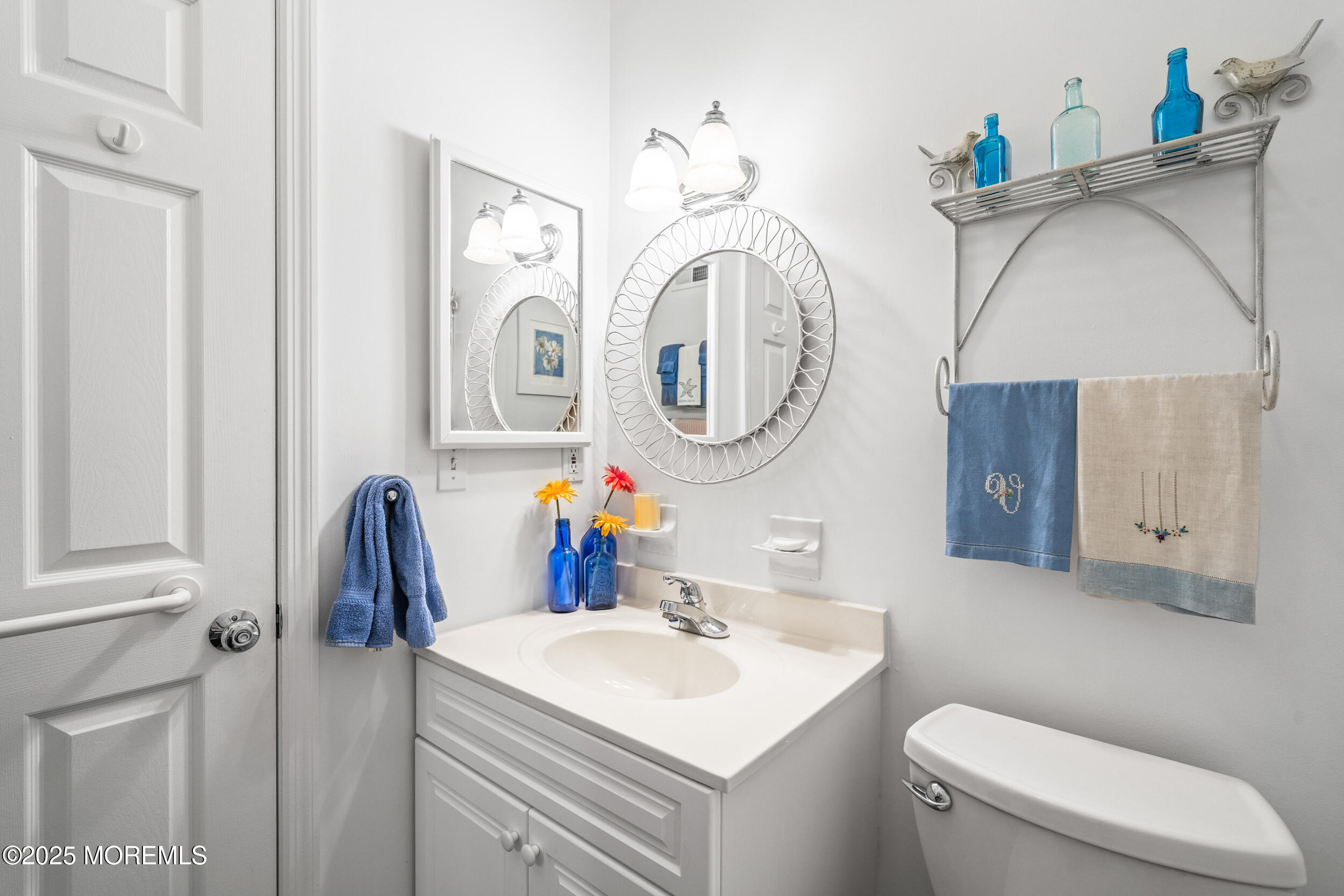 4 Ocean Avenue, Unit 5 Ocean Grove, NJ 07756 - Photo 11 of 81 a bathroom with a toilet a sink and a mirror