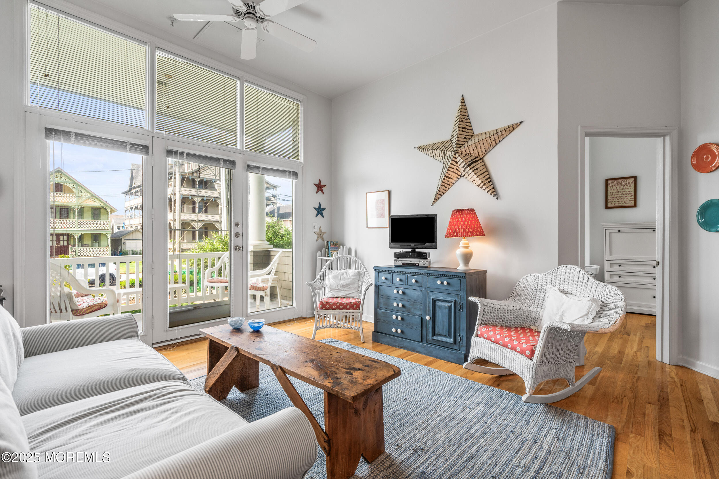 4 Ocean Avenue, Unit 5 Ocean Grove, NJ 07756 - Photo 2 of 81 a living room with furniture a flat screen tv and a floor to ceiling window