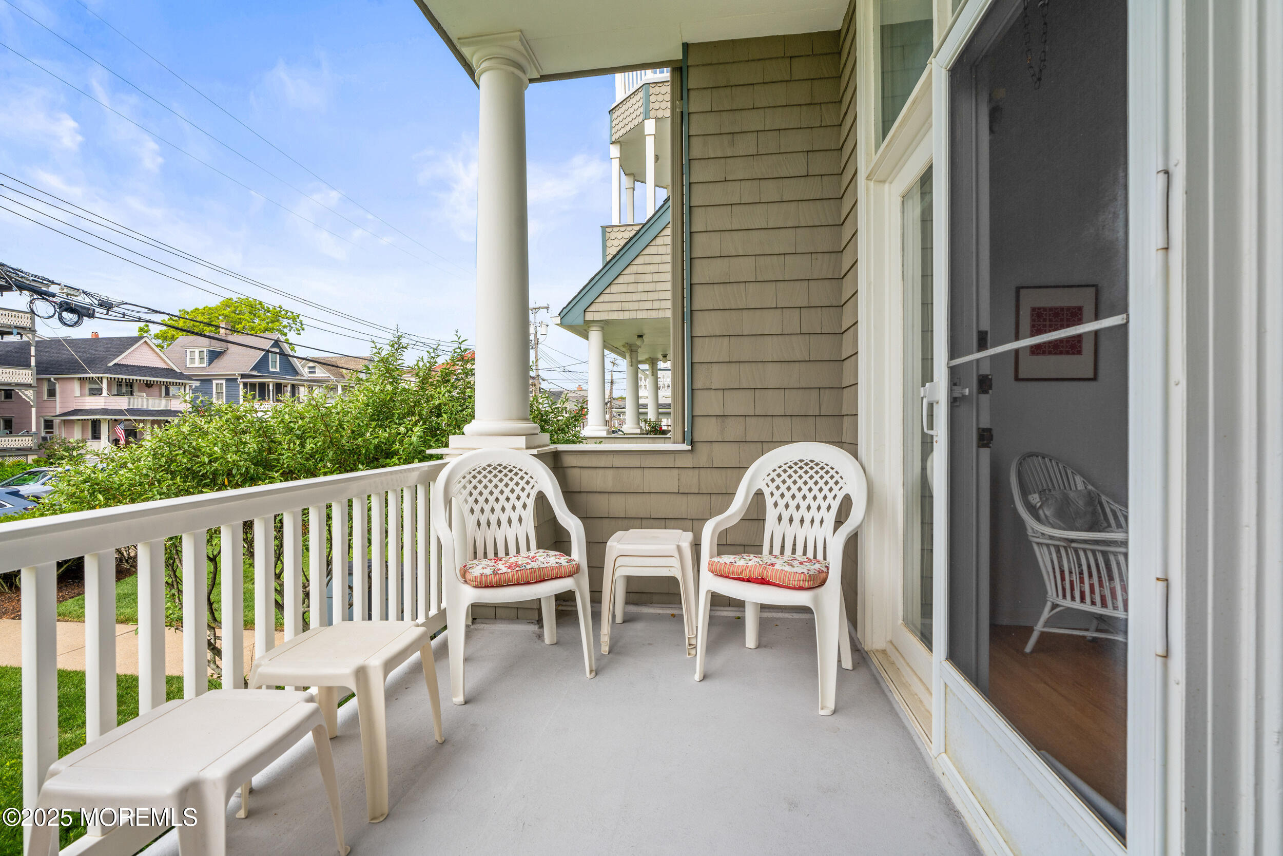 4 Ocean Avenue, Unit 5 Ocean Grove, NJ 07756 - Photo 24 of 81 a balcony with chairs and wooden floor