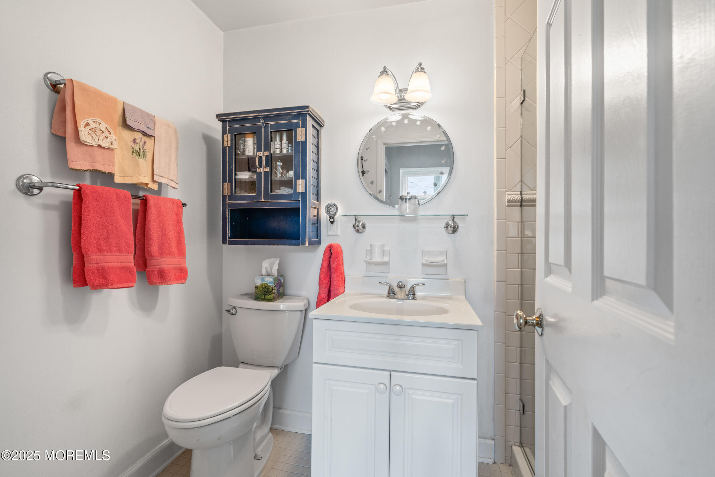 4 Ocean Avenue, Unit 5 Ocean Grove, NJ 07756 - Photo 31 of 81 a bathroom with a sink toilet vanity and mirror