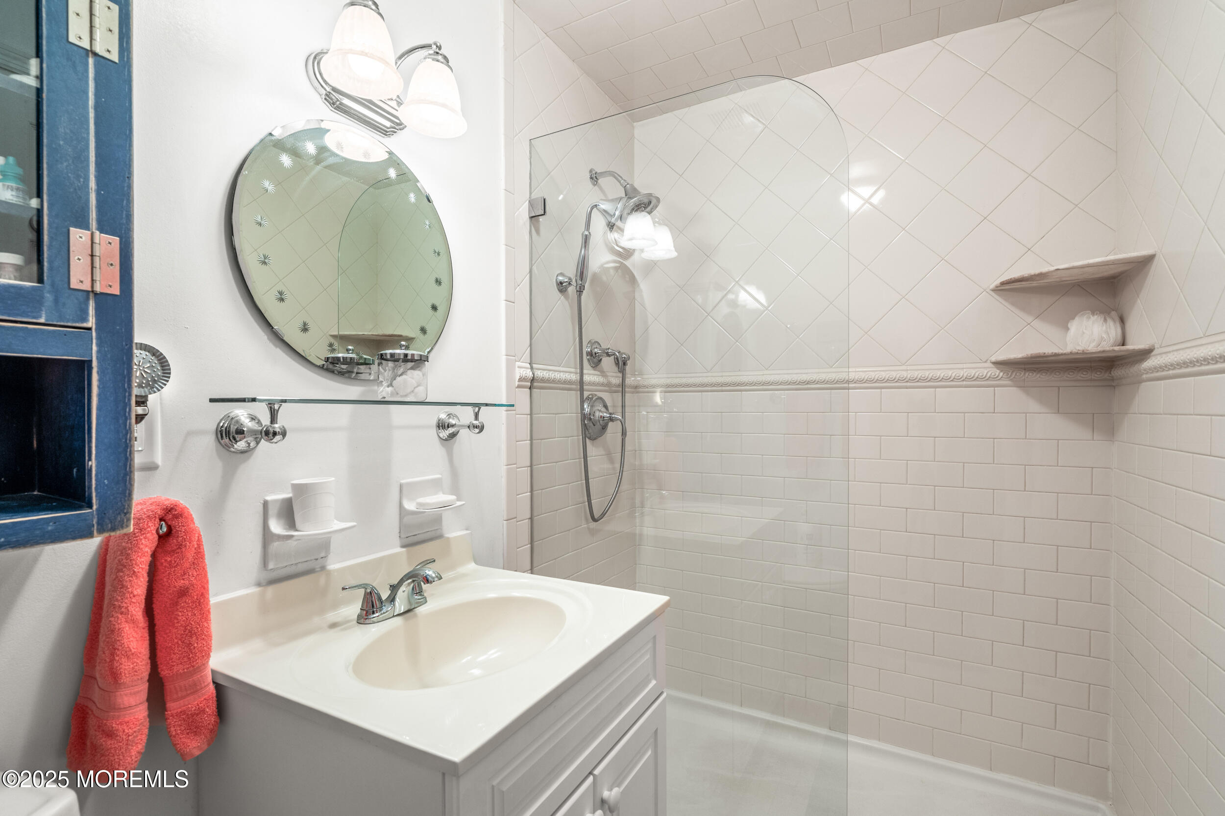 4 Ocean Avenue, Unit 5 Ocean Grove, NJ 07756 - Photo 32 of 81 a bathroom with a sink vanity and a mirror