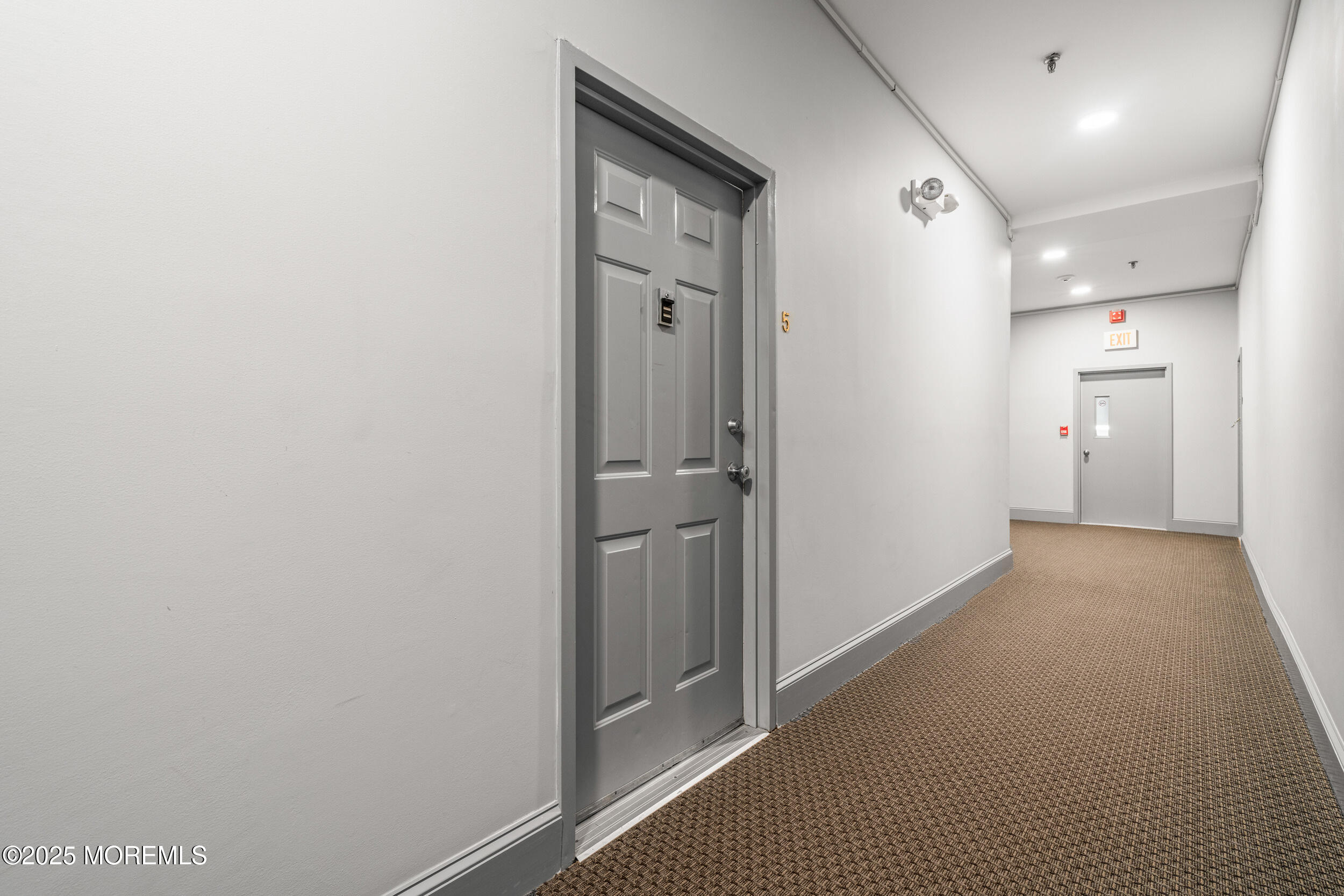 4 Ocean Avenue, Unit 5 Ocean Grove, NJ 07756 - Photo 7 of 81 a view of a hallway with closet and mirror