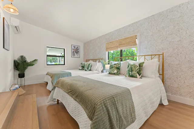 a bedroom with bed and a potted plant