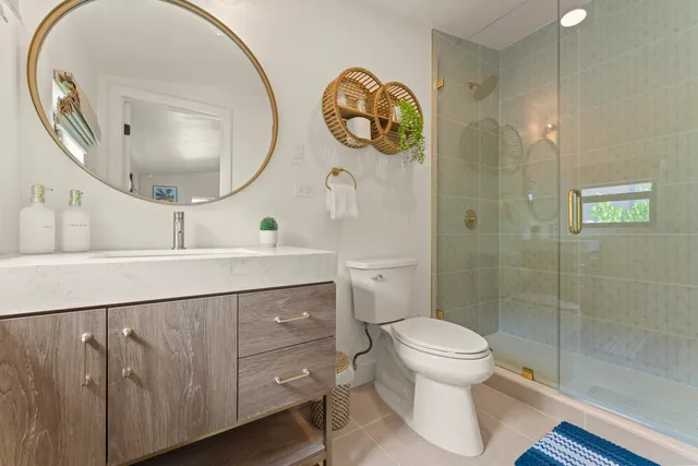 a bathroom with a toilet a sink and a mirror