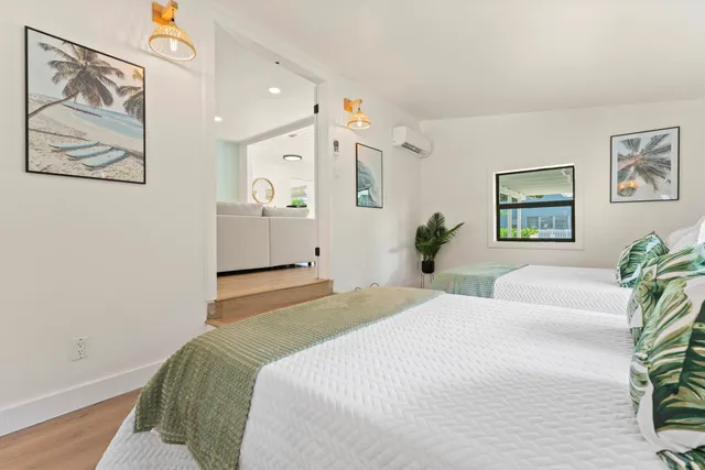 a bedroom with a large bed and a chandelier