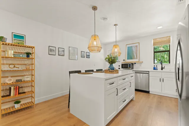 a kitchen with sink stove and cabinets
