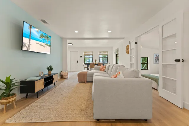 a living room with furniture potted plant and a table