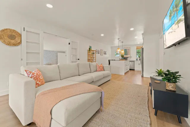 a living room with furniture and flowers