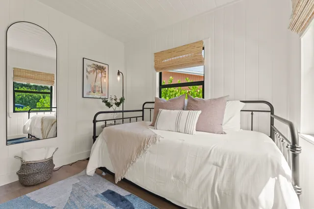 a bedroom with bed and a window