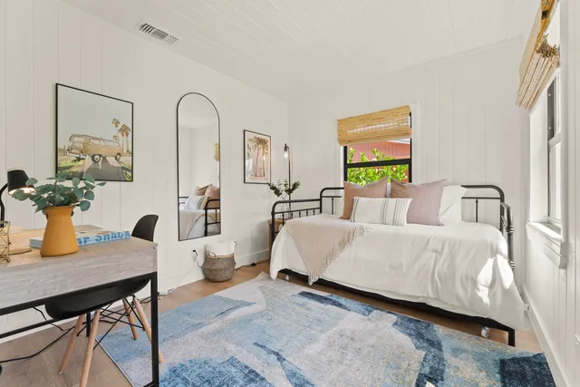 a bed room with a bed and a table