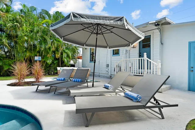 a view of backyard with seating space and wooden floor