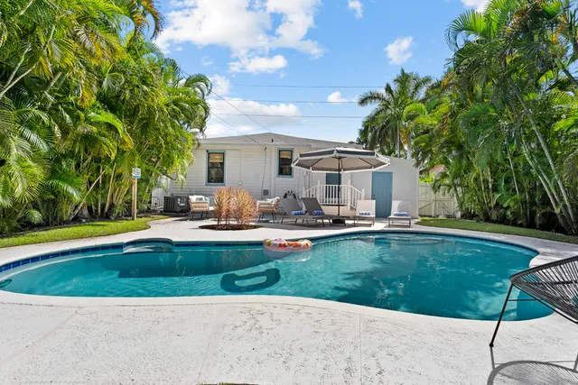 a swimming pool with outdoor seating and yard