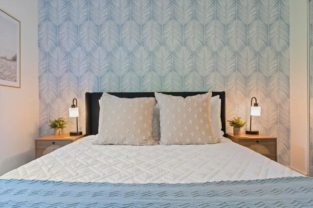 a bedroom with a bed and mirror