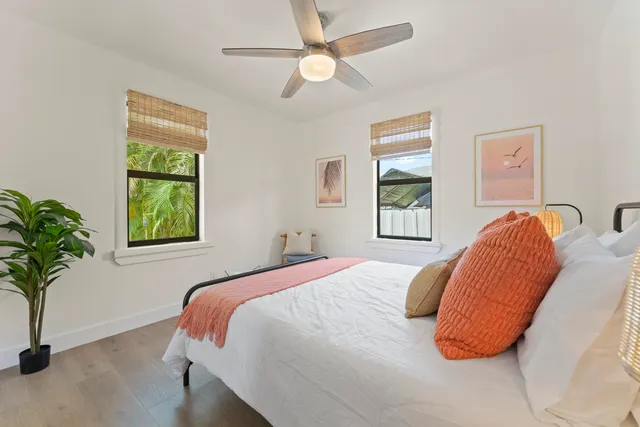 a bed sitting in a bedroom next to a window