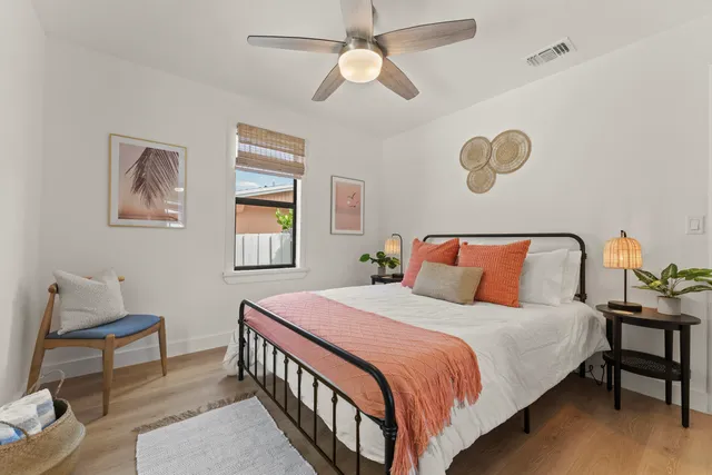 a bedroom with a bed and a chandelier