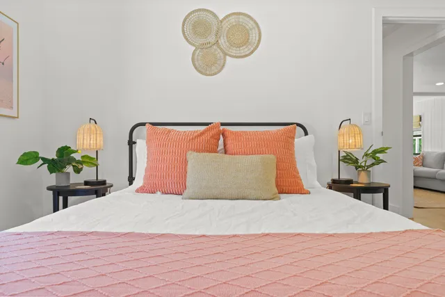 a bedroom with a bed flowerpot and a chandelier