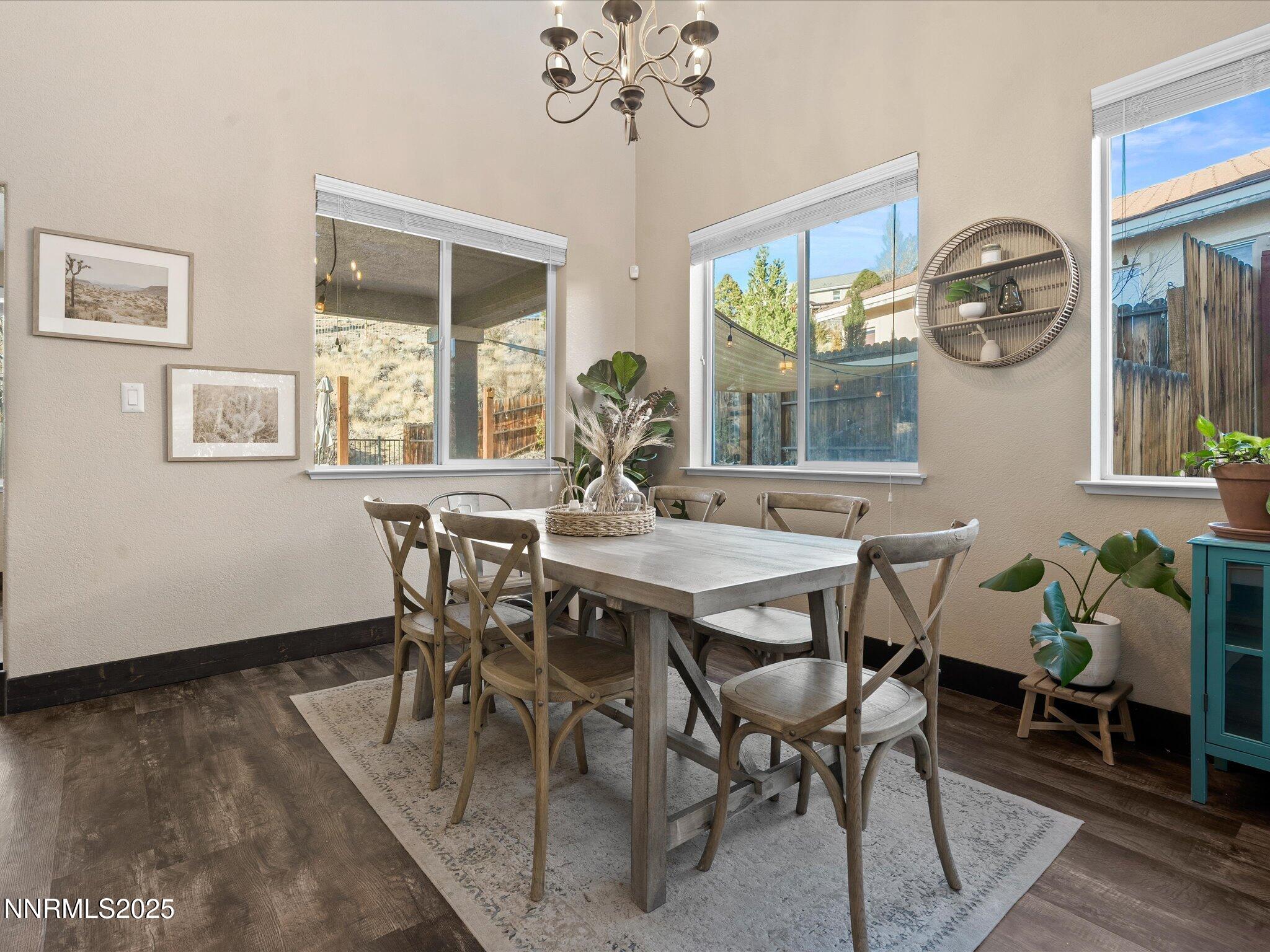 7227 Heatherwood Drive Reno, NV 89523 - Photo 17 of 55 a view of a dining room with furniture wooden floor and chandelier