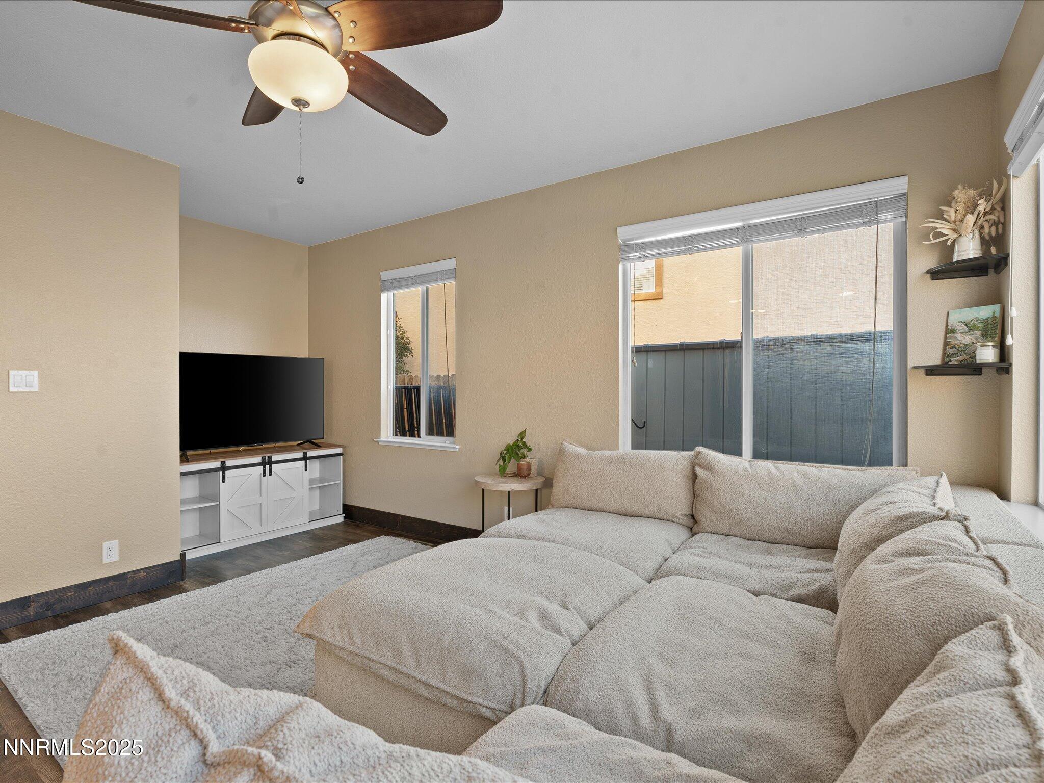 7227 Heatherwood Drive Reno, NV 89523 - Photo 27 of 55 a living room with couches and a flat screen tv