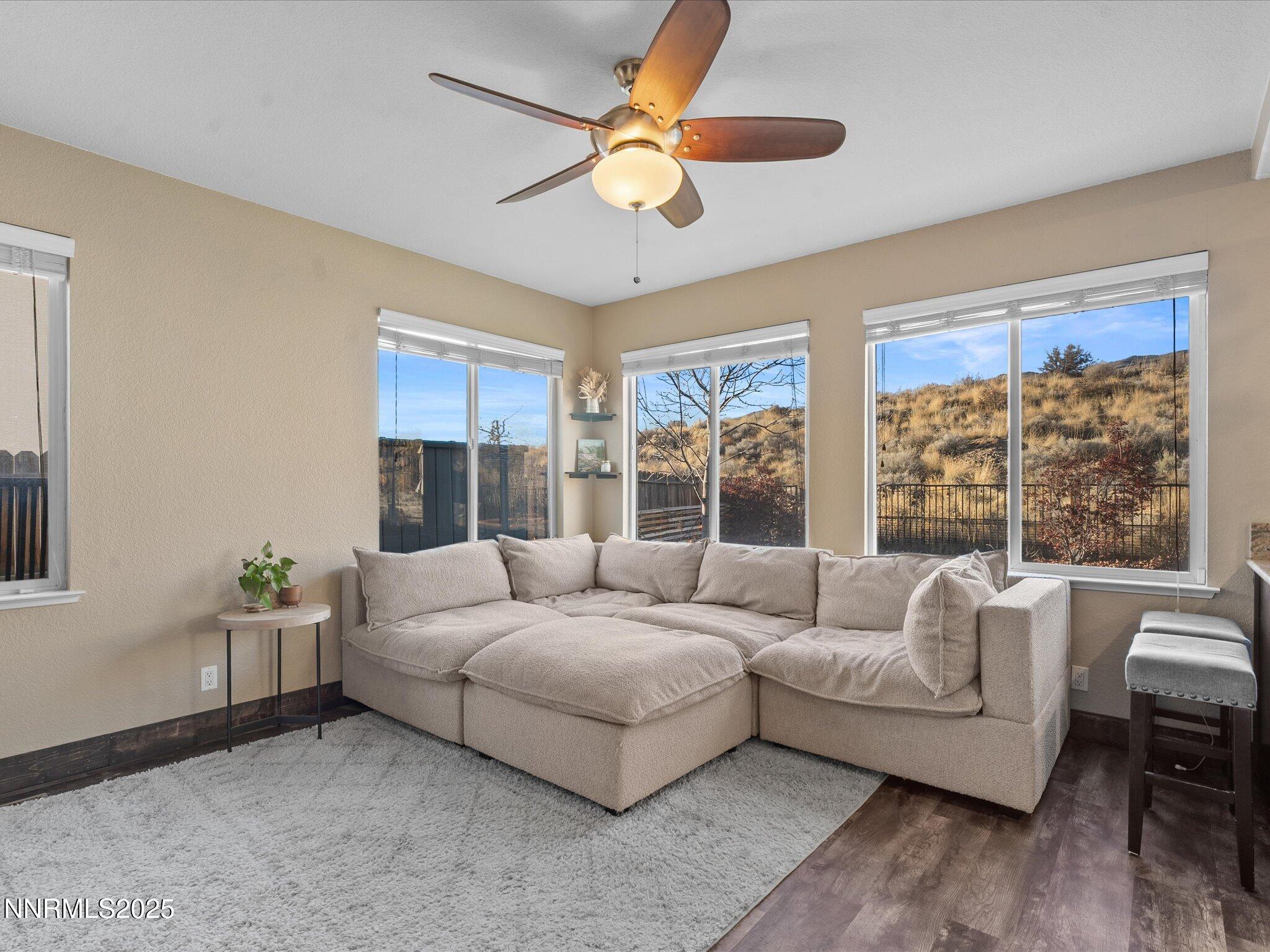 7227 Heatherwood Drive Reno, NV 89523 - Photo 28 of 55 a living room with furniture and a large window with wooden floor