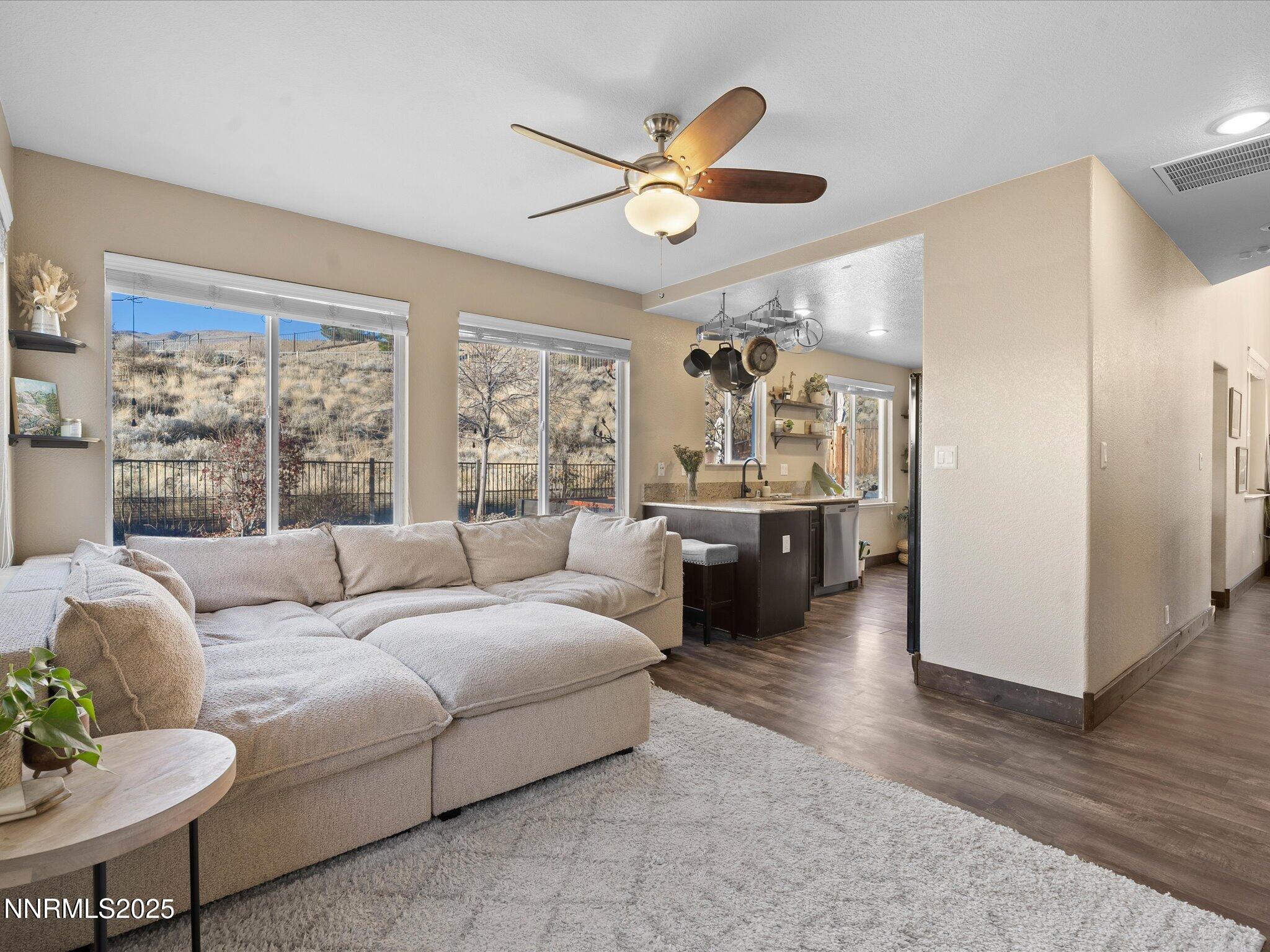 7227 Heatherwood Drive Reno, NV 89523 - Photo 29 of 55 a living room with furniture and a large window with kitchen view