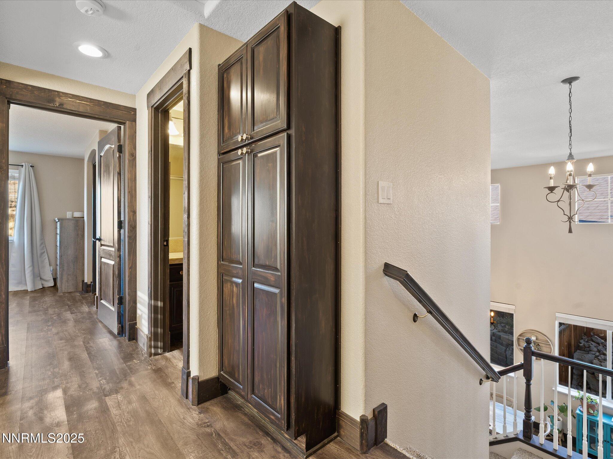 7227 Heatherwood Drive Reno, NV 89523 - Photo 32 of 55 a view of a hallway with wooden floor and staircase