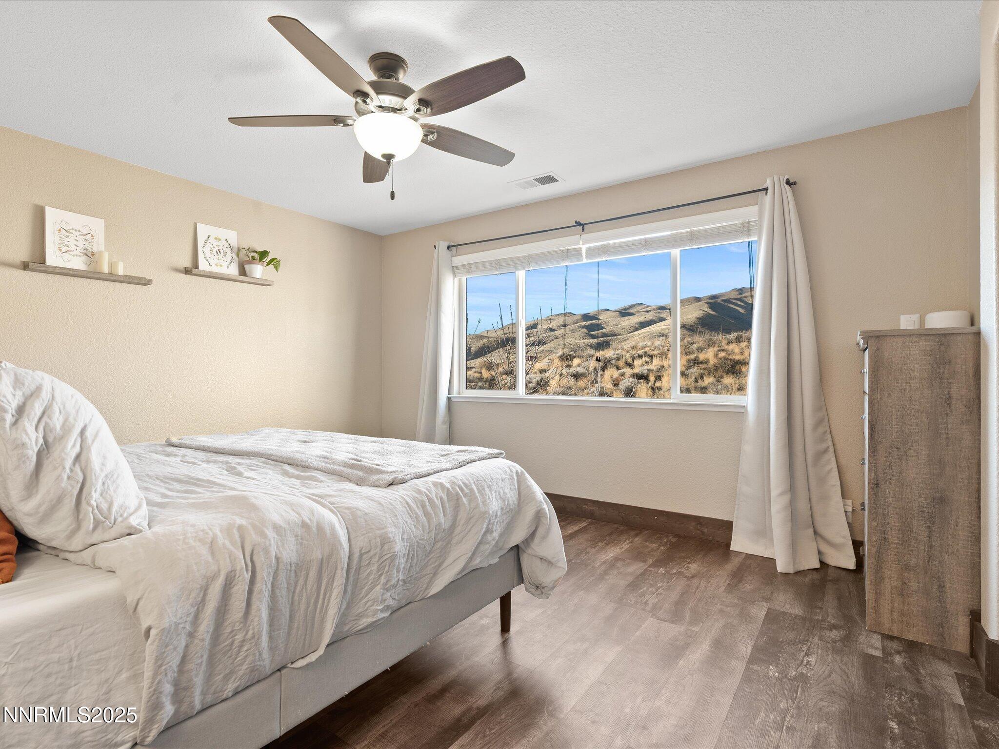 7227 Heatherwood Drive Reno, NV 89523 - Photo 35 of 55 a bedroom with a large bed and a window