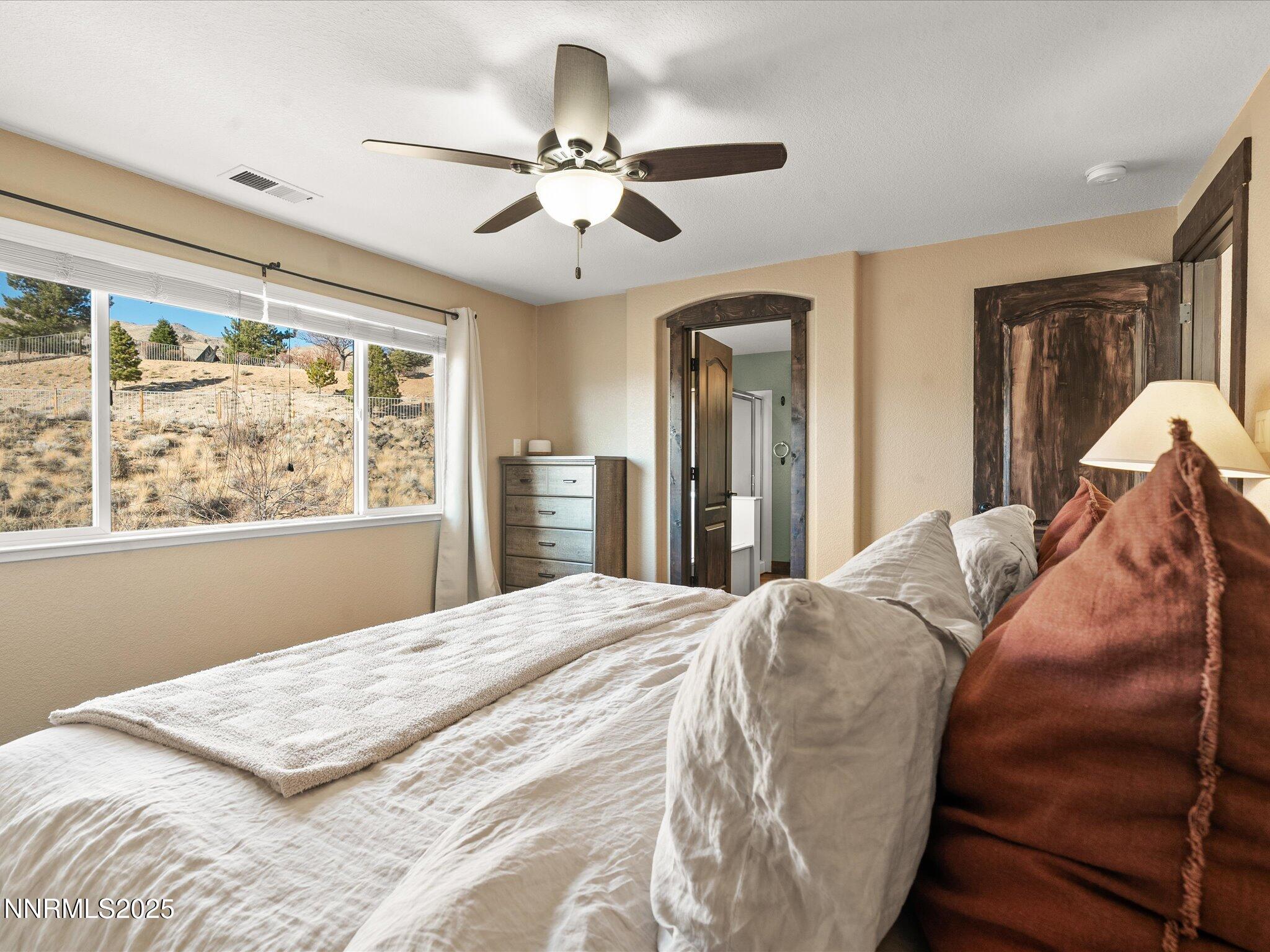 7227 Heatherwood Drive Reno, NV 89523 - Photo 37 of 55 a bedroom with a large bed and a window