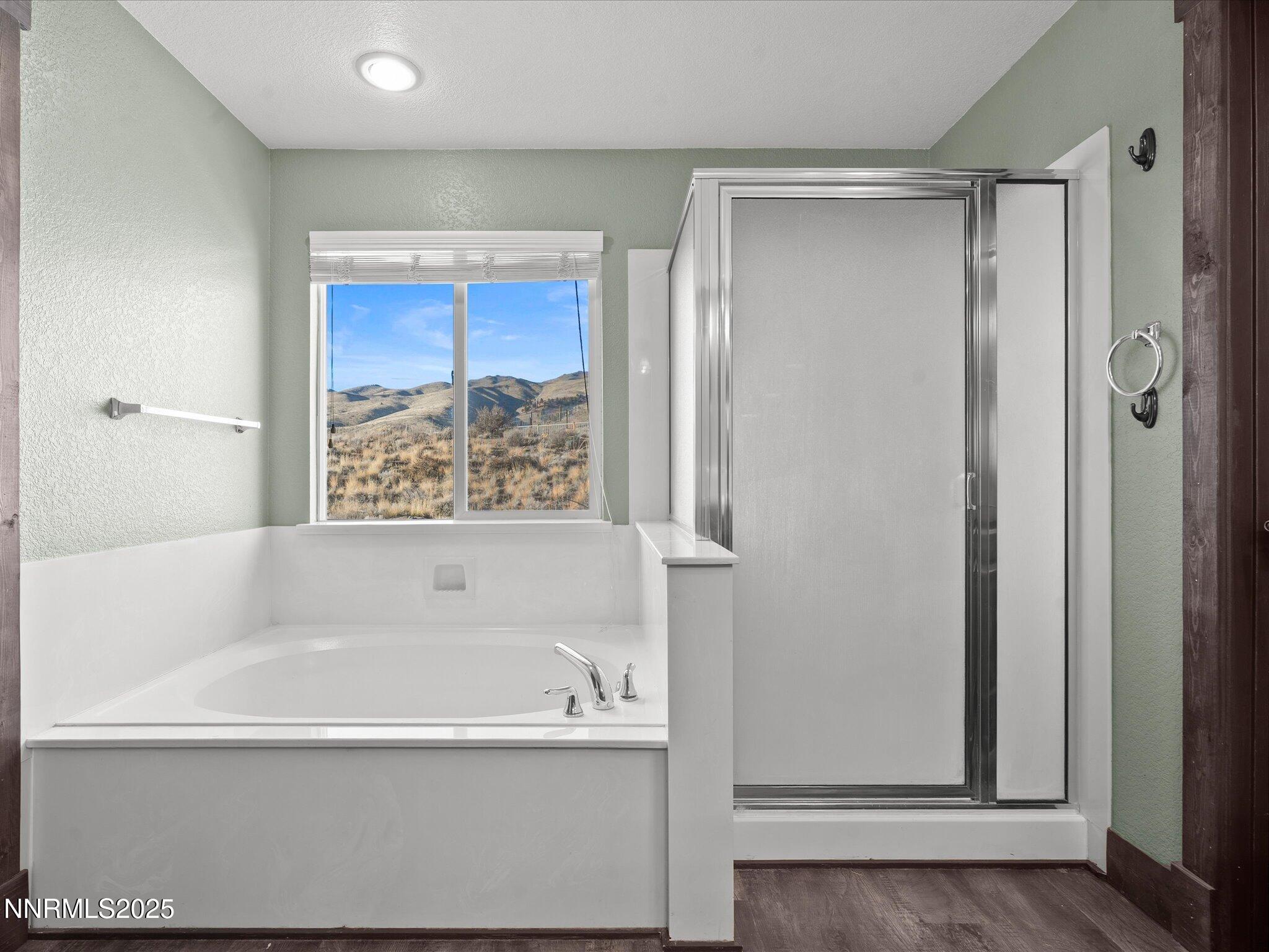 7227 Heatherwood Drive Reno, NV 89523 - Photo 38 of 55 a bathroom with bathtub and a shower