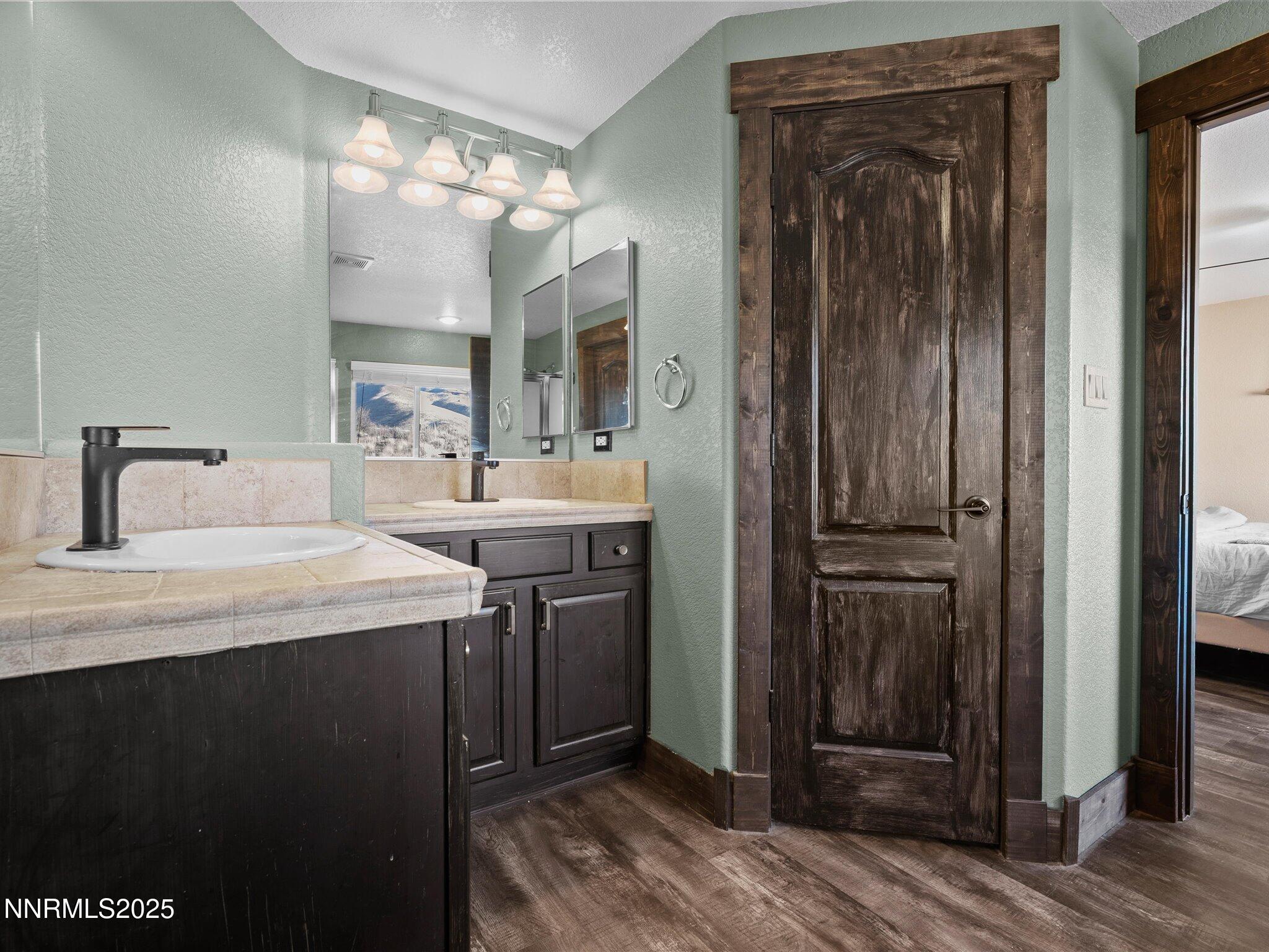 7227 Heatherwood Drive Reno, NV 89523 - Photo 39 of 55 a room with a sink and a mirror