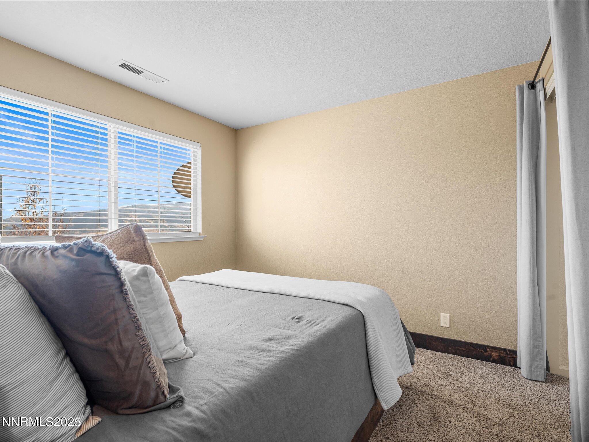 7227 Heatherwood Drive Reno, NV 89523 - Photo 41 of 55 a bedroom with a bed and a window