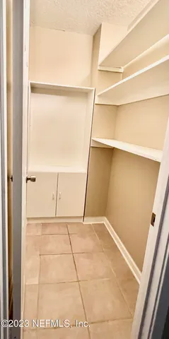 a sign that is sitting in front of a tree