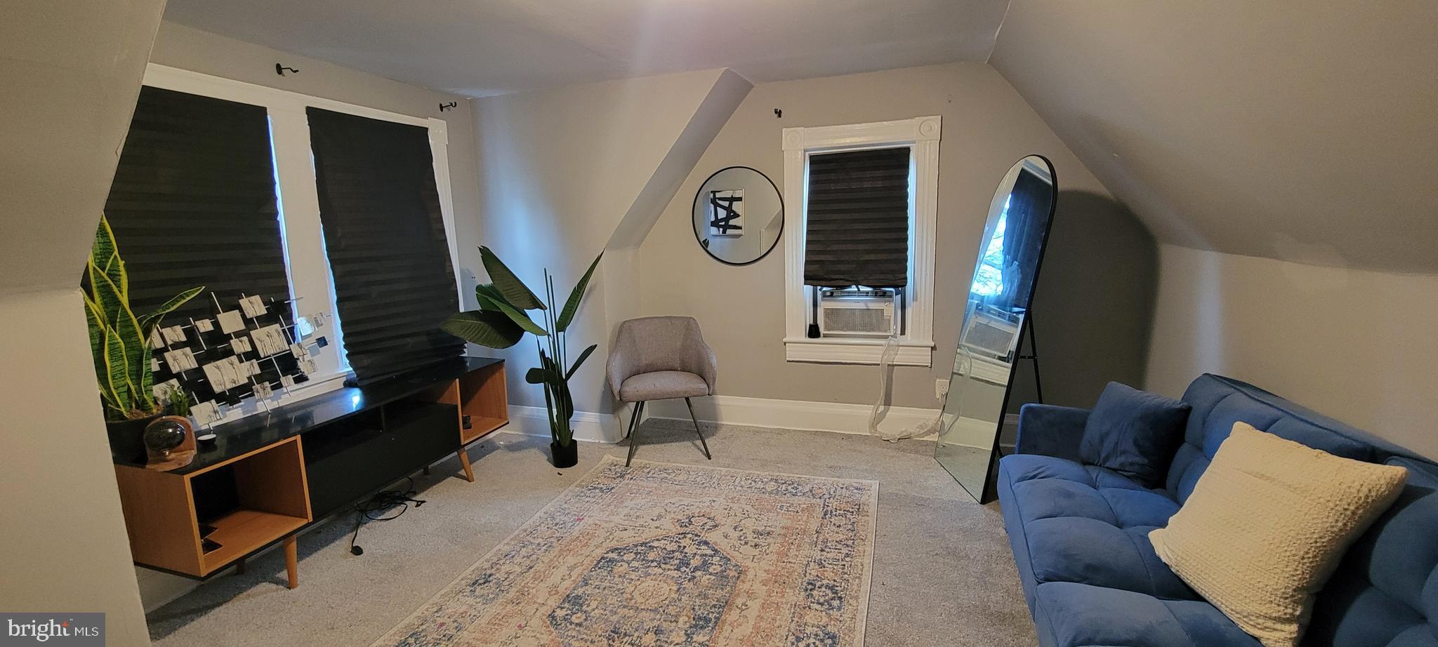 4002 Belvieu Avenue, Unit 3 Baltimore, MD 21215 - Photo 2 of 10 a living room with furniture and a flat screen tv