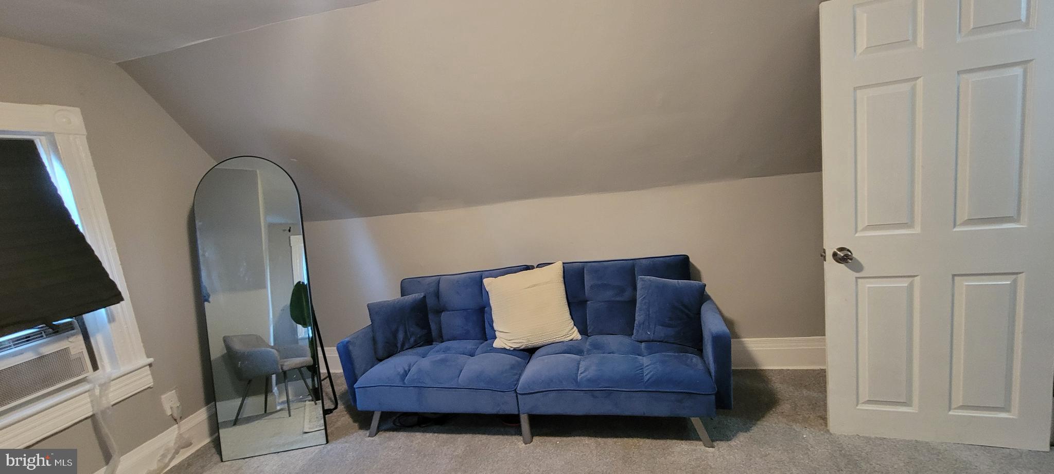 4002 Belvieu Avenue, Unit 3 Baltimore, MD 21215 - Photo 3 of 10 a living room with furniture and a couch