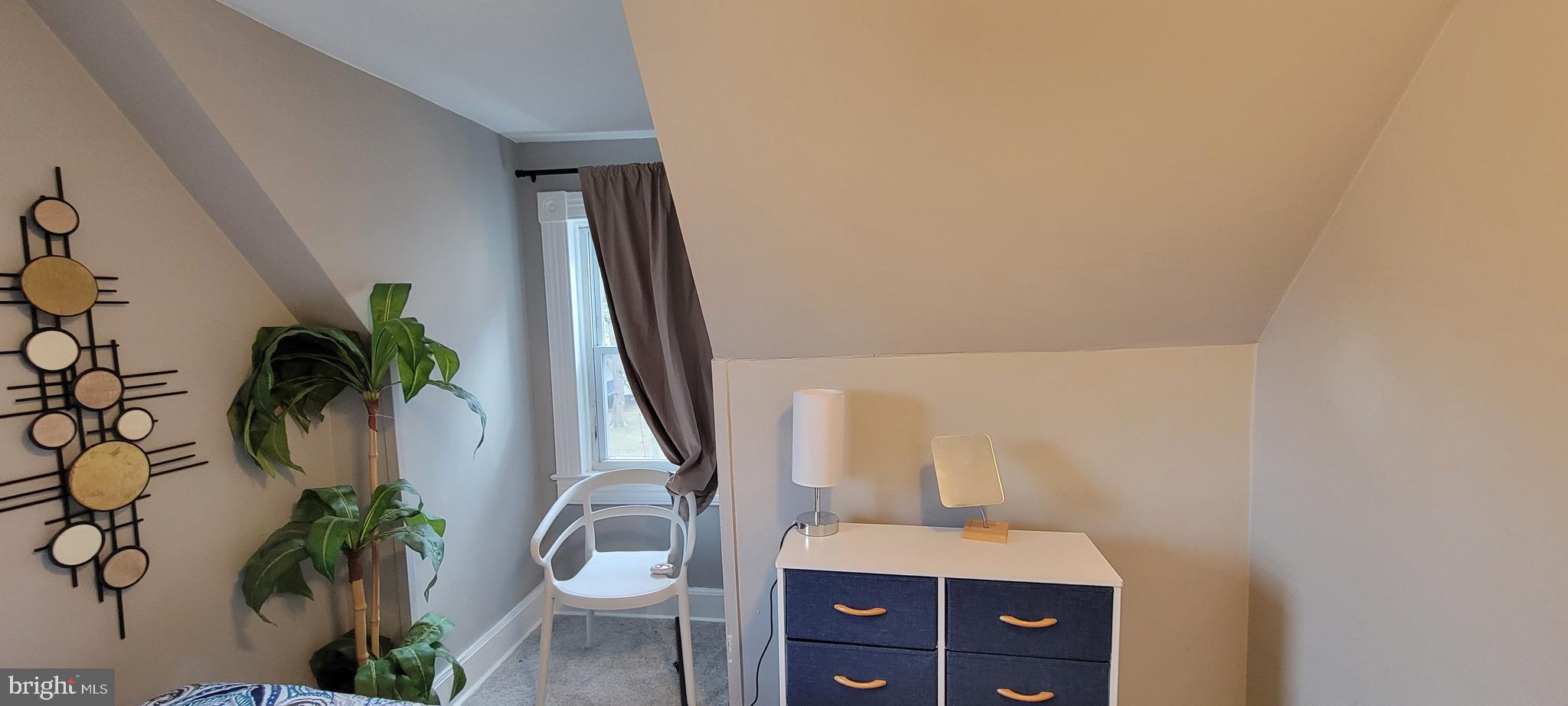 4002 Belvieu Avenue, Unit 3 Baltimore, MD 21215 - Photo 6 of 10 a bathroom with a granite countertop sink a potted plant and a mirror