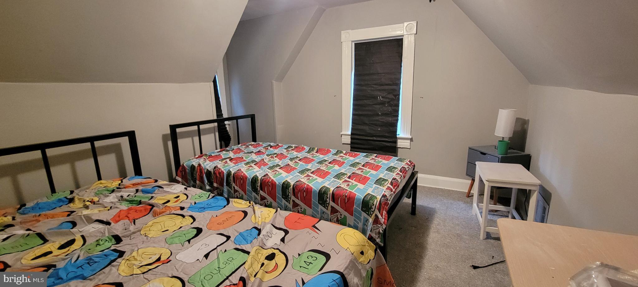 4002 Belvieu Avenue, Unit 3 Baltimore, MD 21215 - Photo 7 of 10 a bedroom with a bed and wooden floor