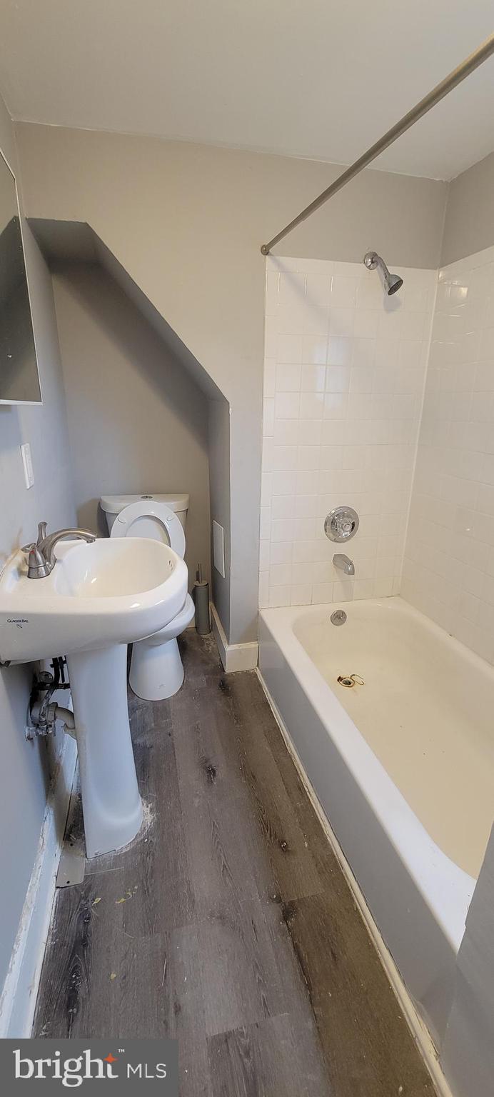 4002 Belvieu Avenue, Unit 3 Baltimore, MD 21215 - Photo 10 of 10 a bathroom with a sink toilet and bathtub