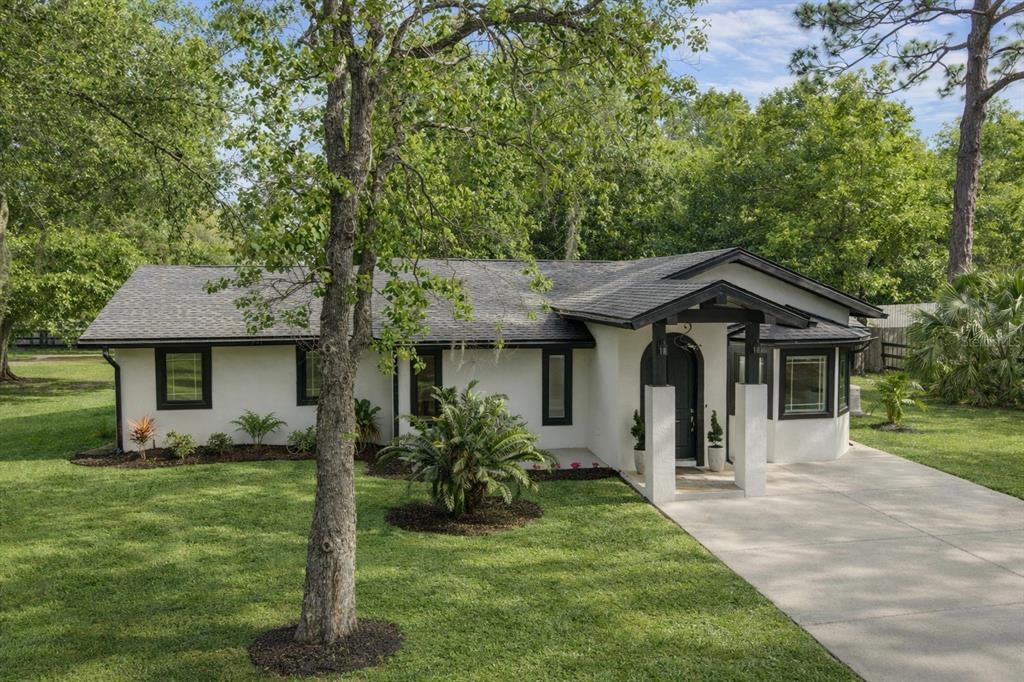 5721 Southwest 31st Street Ocala, FL 34474 - Photo 1 of 41 a front view of a house with a yard