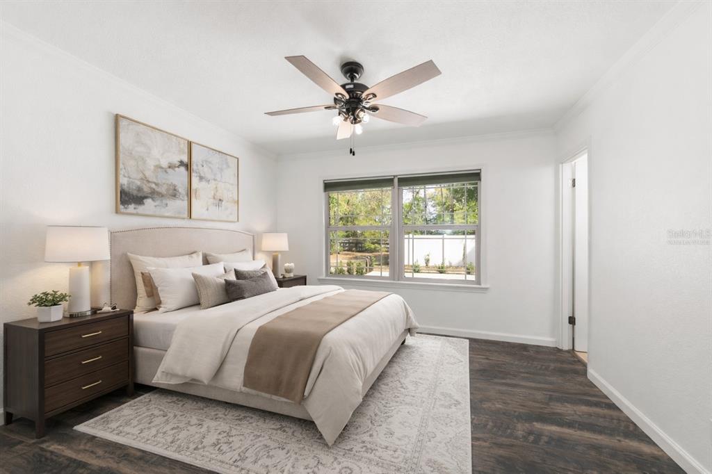 5721 Southwest 31st Street Ocala, FL 34474 - Photo 11 of 41 a bedroom with a large bed and a window