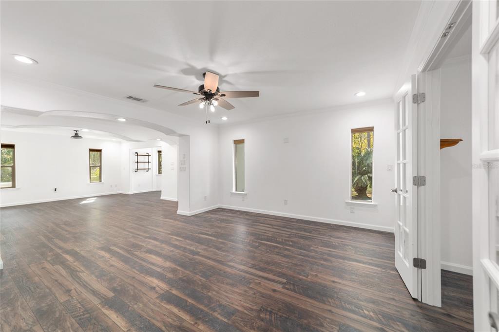 5721 Southwest 31st Street Ocala, FL 34474 - Photo 13 of 41 a view of an empty room with wooden floor and a window