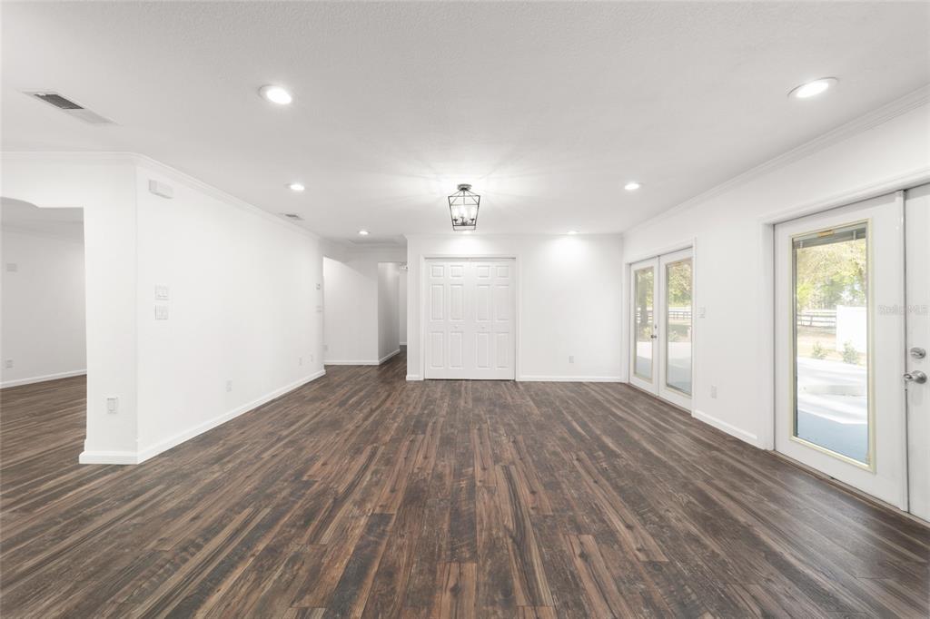 5721 Southwest 31st Street Ocala, FL 34474 - Photo 16 of 41 a view of empty room with wooden floor and windows