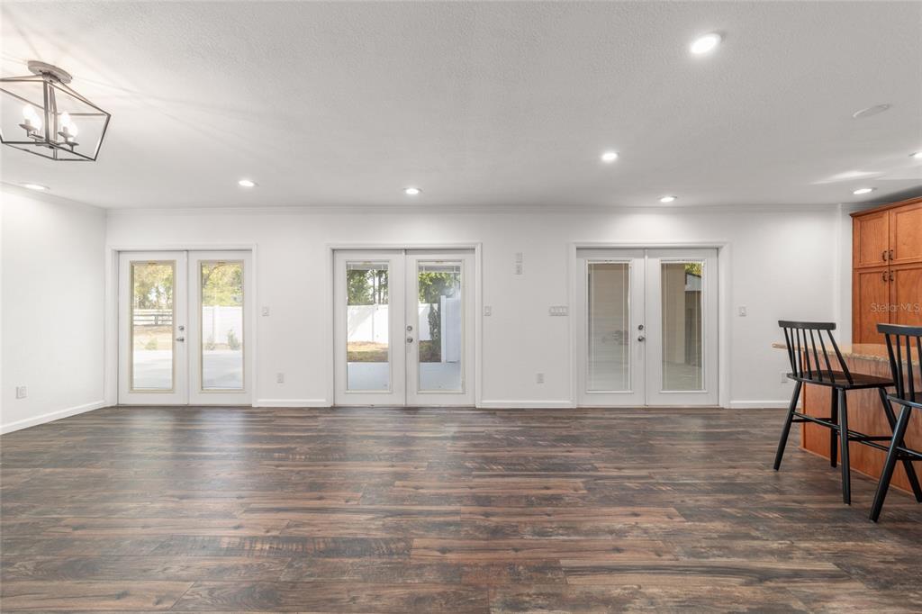 5721 Southwest 31st Street Ocala, FL 34474 - Photo 17 of 41 a view of an empty room with wooden floor and a window