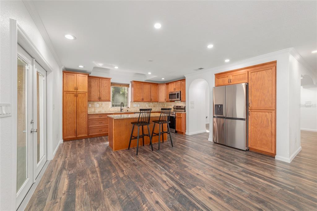 5721 Southwest 31st Street Ocala, FL 34474 - Photo 19 of 41 a kitchen with stainless steel appliances wooden floor and a refrigerator