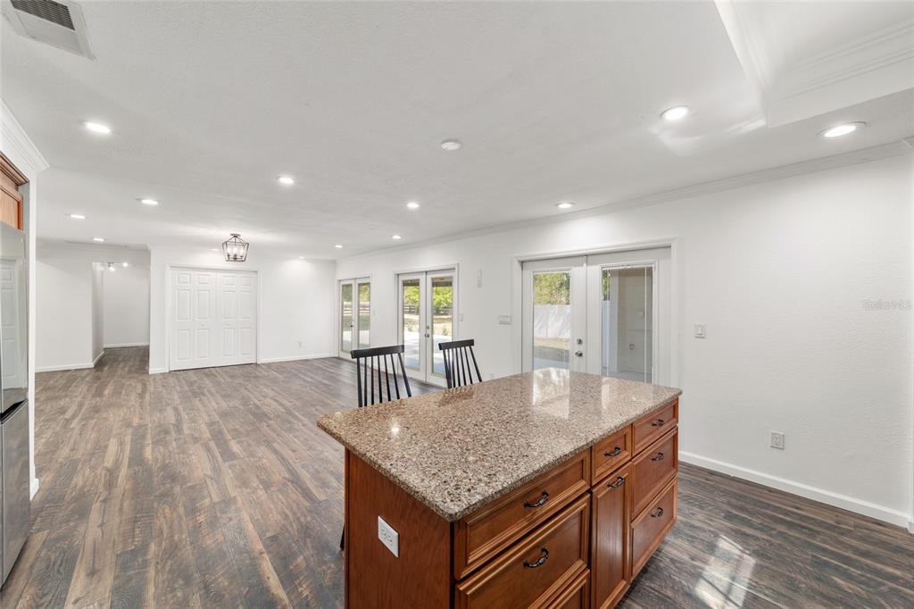 5721 Southwest 31st Street Ocala, FL 34474 - Photo 21 of 41 a kitchen with kitchen island stainless steel appliances a dining table and chairs