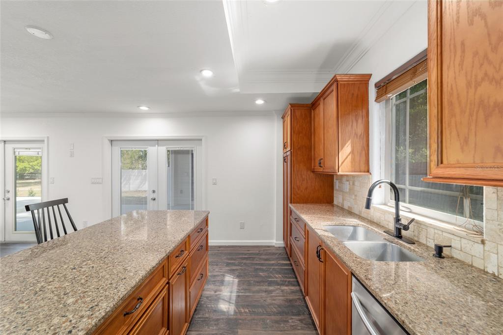5721 Southwest 31st Street Ocala, FL 34474 - Photo 22 of 41 a kitchen with granite countertop a sink a counter top space and stainless steel appliances