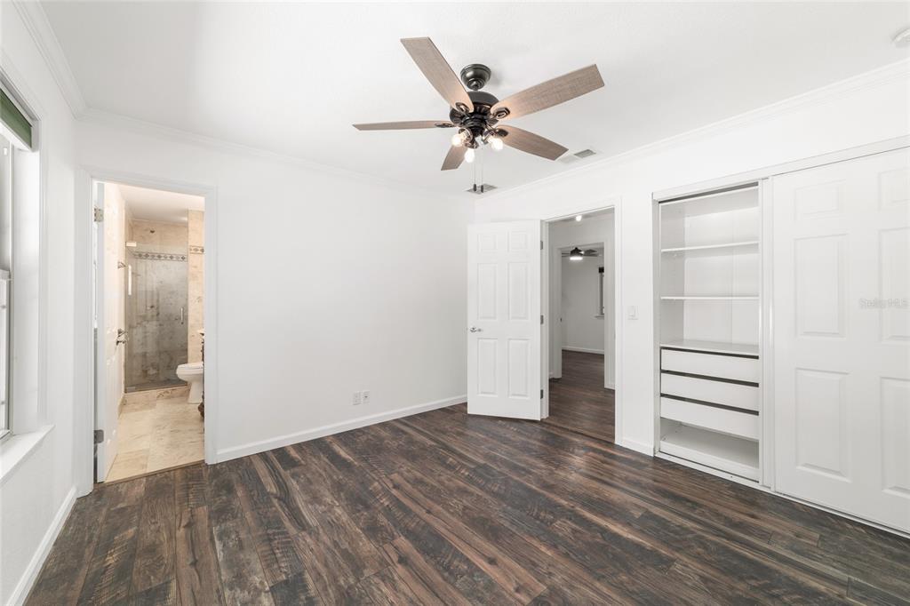 5721 Southwest 31st Street Ocala, FL 34474 - Photo 25 of 41 an empty room with wooden floor closet and windows