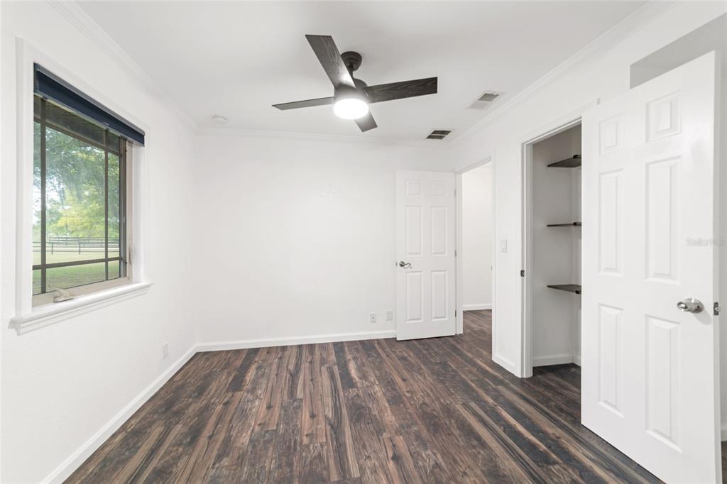 5721 Southwest 31st Street Ocala, FL 34474 - Photo 28 of 41 a view of a livingroom with wooden floor and a ceiling fan
