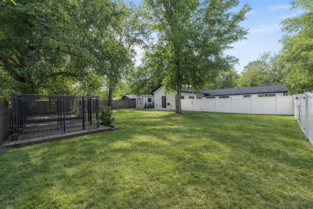 5721 Southwest 31st Street Ocala, FL 34474 - Photo 35 of 41 a view of a backyard with a small cabin and wooden fence